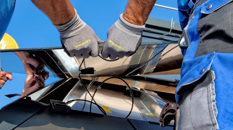 Installer mounting panels on a new roof
